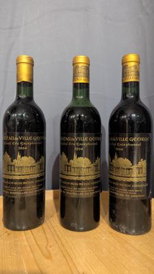 four bottles of wine are lined up on a wooden table