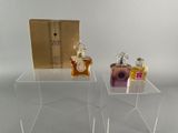 clear acrylic acrylic display stands with perfume bottles on them