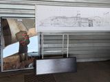 a man standing in front of a drawing of a submarine