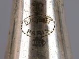 a close up of a silver bell on a table