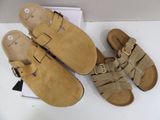 two pairs of tan sandals with buckles on them sitting on a box