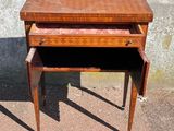 a small wooden table with a drawer on top of it