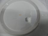 a white plate with a black and yellow design on it