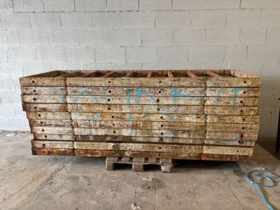 a pile of wood sitting on a pallet in a warehouse