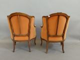 a pair of antique chairs with orange upholstered upholstered seats