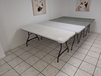 three tables that are sitting in the corner of the room