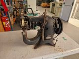 an old sewing machine sitting on top of a table in a room