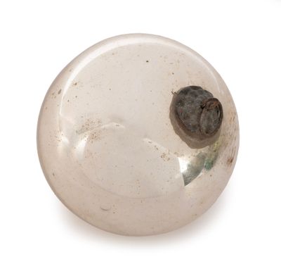 a glass object with a heart in it on a white surface