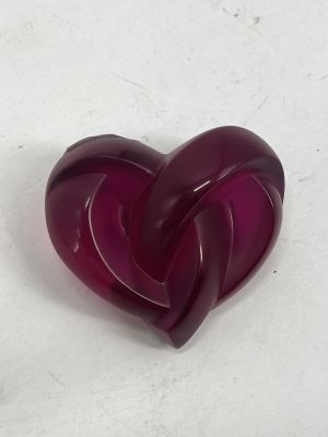 a purple heart shaped object on a white surface