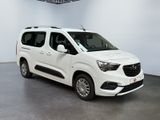 the white van is parked in a white room with a black floor