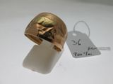 a gold ring with a picture of a woman on it