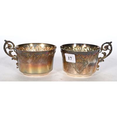 a pair of silverplated bowls with handles and handles