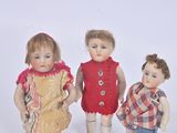 three dolls that are standing next to each other