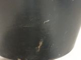 a close up of a black pot on a table