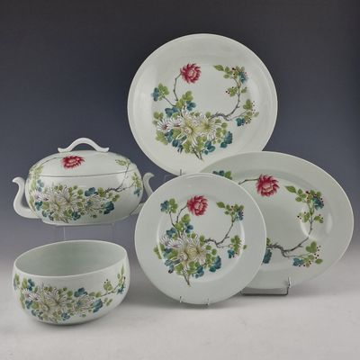 four pieces of china on display on a table