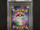 a close up of a pokemon card on a black surface