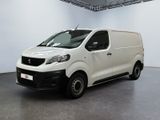 the small white van is parked in a large room