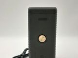 a close up of a black electronic device on a white surface