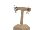 a close up of a pair of earrings on a stand