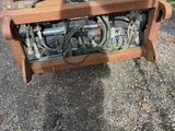 a small machine that is on the ground by the fence