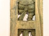 a wooden carving of a man and a woman