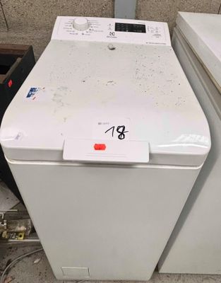two washing machines sitting next to each other on the floor