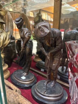 a display case with a couple of bronze figurines on it