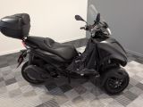 a picture of a black motorcycle parked on a checkered floor