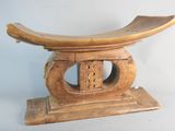a wooden bench with a curved design on top of it
