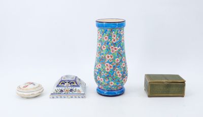 a blue vase and a small box on a white surface