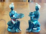 two figurines that are sitting on a table