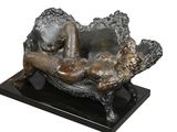 statue of a woman laying on a shell on a marble base