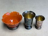 three cups and a bowl sitting on a table