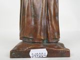 bronze statue of a man with a hat and robe on a base