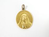 a close up of a gold medal on a white surface