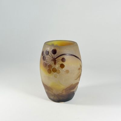 a glass vase with a flower design on it