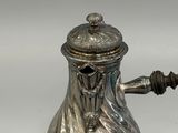 silver plated coffee pot with a handle and a lid