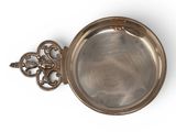 an antique silver plate with a key on a white background