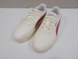 pair of white and pink puma sneakers on a white surface