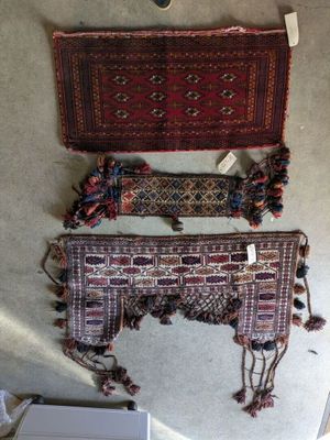 two pieces of rugs and a rug on a table