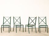 three green chairs sitting next to each other against a white wall