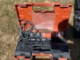 two tools that are sitting in the grass