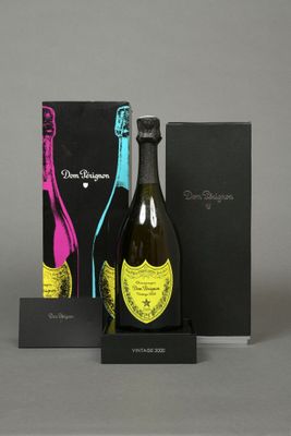 a bottle of champagne and a box of wine on a table