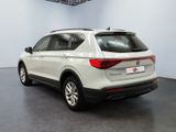 the rear end of a white volkswagen suv parked in a garage