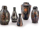 five vases that have been decorated with designs on them
