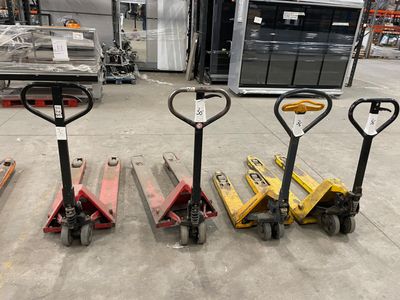several forklifts are lined up in a row in a warehouse