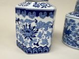 two blue and white vases sitting next to each other