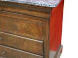 a wooden chest of drawers with a marble top