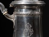 silver plated coffee pot with ornate handle and lid