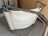 a white chair with a metal arm rest and a white chair with a metal arm rest and a white chair with a metal arm rest and a white chair